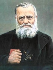 An elderly man with a white beard, wearing glasses and a cross necklace, stands against a neutral background, reminiscent of the serene and wise presence associated with Blessed Joseph Gerard.