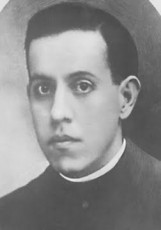 A black and white portrait of Blessed Miguel Pro, a man wearing a clergy collar, gazes directly at the camera.