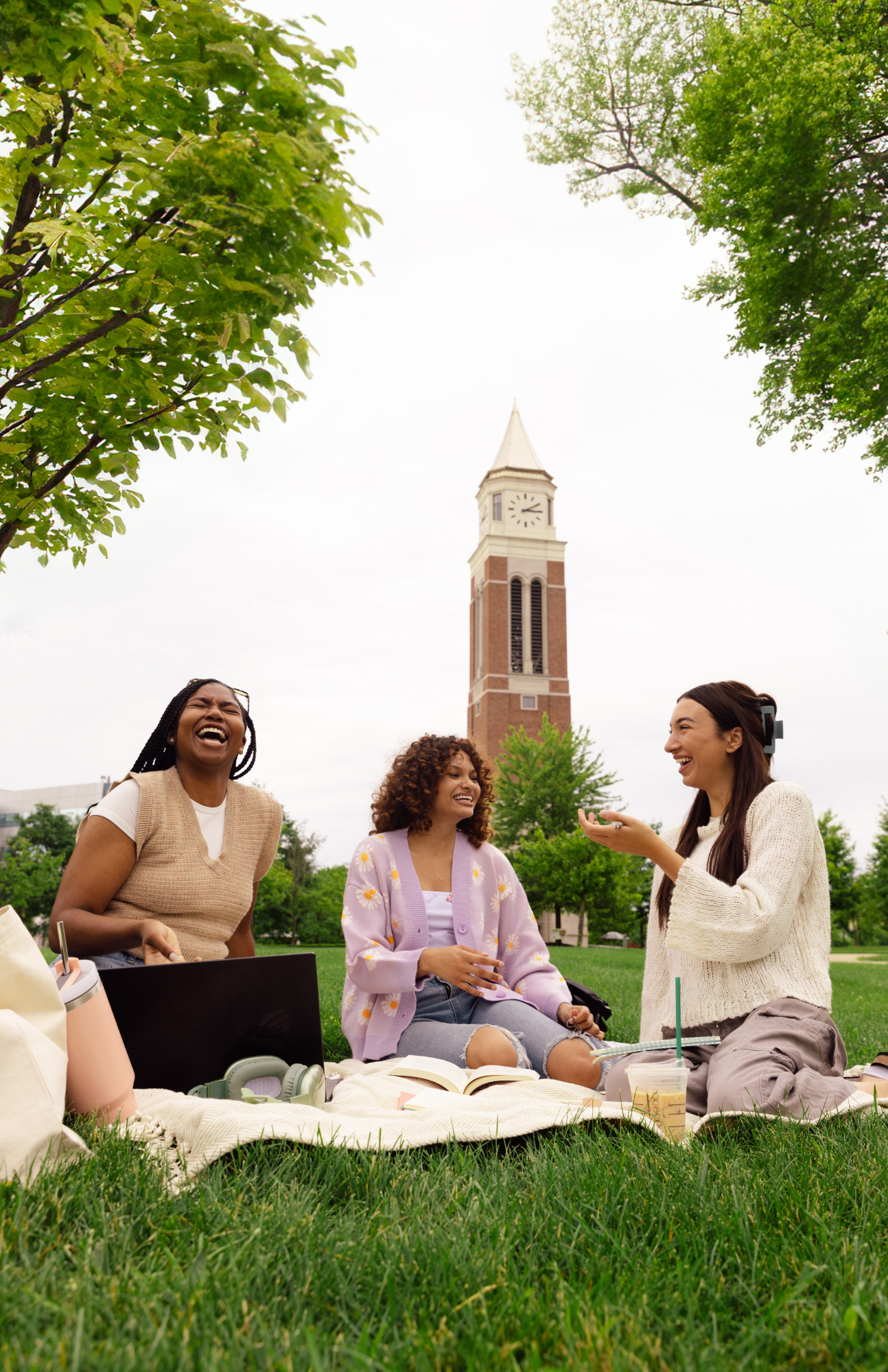 group of girls studying on lawn at college